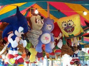 Plushy prizes hanging from a carnival booth